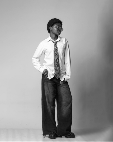 Stylist in a white shirt and patterned tie, studio portrait